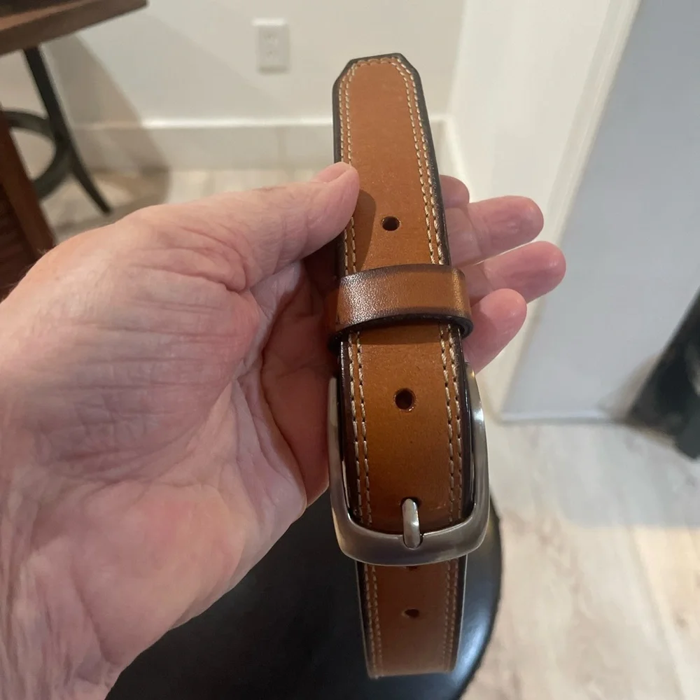 NWOT Genuine leather belt. 31” of leather end to end not including buckle.26/28